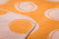 Preview: David Fussenegger Babydecke Juwel mit Stick 'Happy Faces' 70 x 90 cm Hellorange